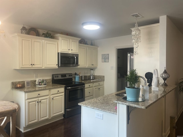 kitchen with stainless steel appliances, a peninsula, dark wood-style floors, light stone counters, and a kitchen breakfast bar