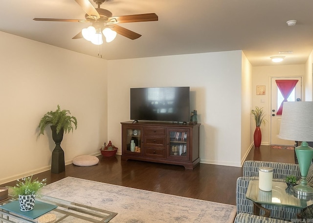 living room with wood finished floors and a ceiling fan