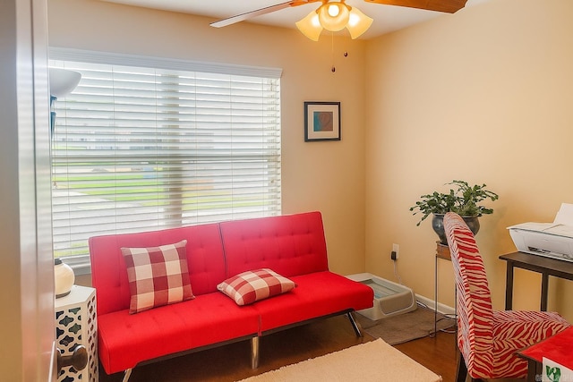 sitting room with a ceiling fan and wood finished floors