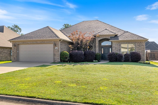 205 Lucia Ln, North Little Rock, AR 72113 - french country home with brick siding, a garage, driveway, and roof with shingles