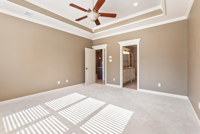 205 Lucia Ln, North Little Rock, AR 72113 - unfurnished bedroom featuring light colored carpet, a tray ceiling, ornamental molding, ensuite bath, and ceiling fan