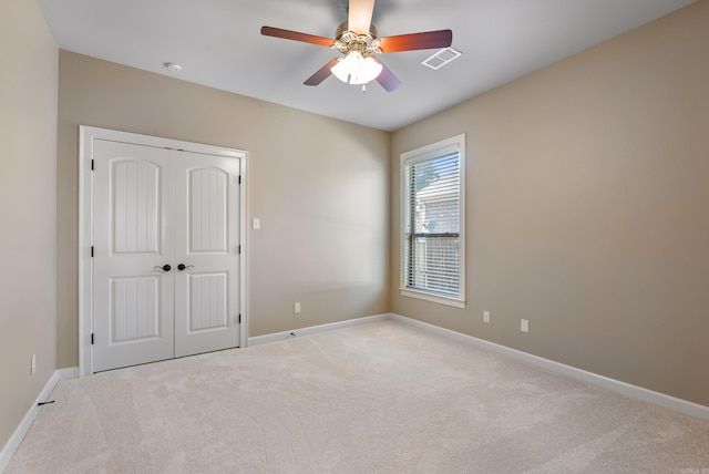 205 Lucia Ln, North Little Rock, AR 72113 - unfurnished bedroom with carpet flooring, a closet, and a ceiling fan