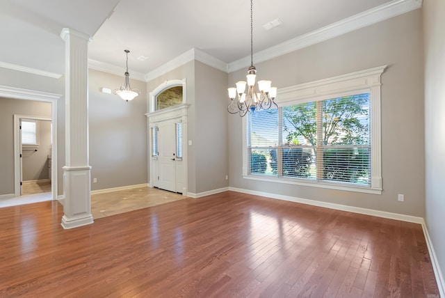 205 Lucia Ln, North Little Rock, AR 72113 - entrance foyer featuring ornate columns, light wood-style floors, crown molding, and a chandelier