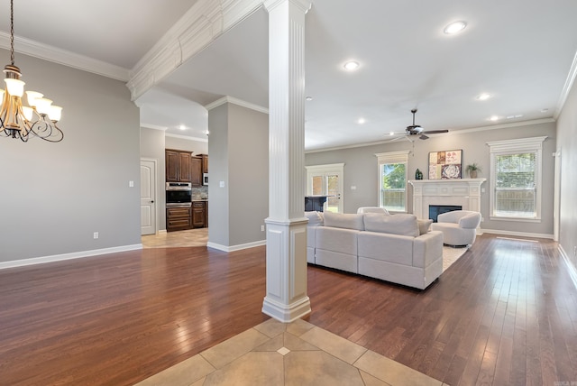 205 Lucia Ln, North Little Rock, AR 72113 - living room with decorative columns, a glass covered fireplace, ceiling fan, dark wood-type flooring, and recessed lighting