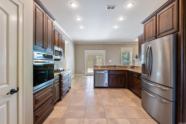 205 Lucia Ln, North Little Rock, AR 72113 - kitchen with stainless steel appliances, ornamental molding, a peninsula, stone counters, and dark brown cabinetry