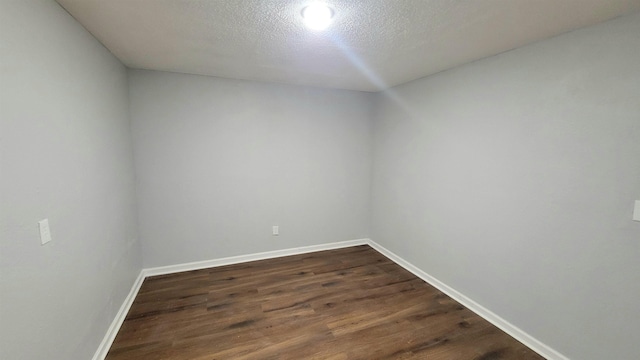 705 Liberty, Marked Tree, AR 72365 - empty room with dark wood finished floors and a textured ceiling