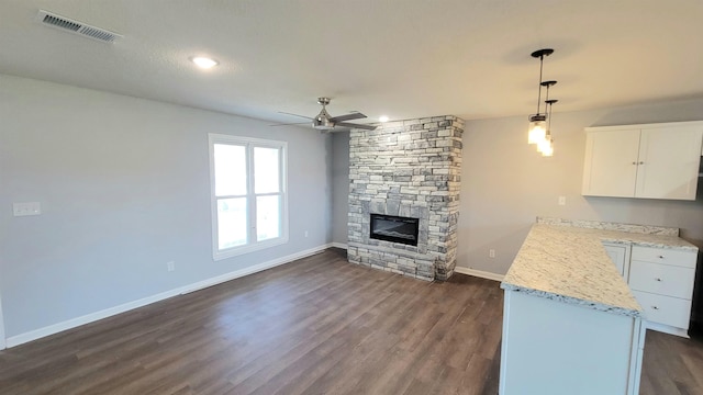 705 Liberty, Marked Tree, AR 72365 - unfurnished living room featuring dark wood finished floors, a ceiling fan, a fireplace, and recessed lighting