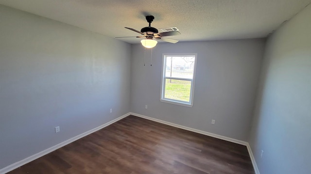 705 Liberty, Marked Tree, AR 72365 - spare room with dark wood-type flooring, ceiling fan, and a textured ceiling