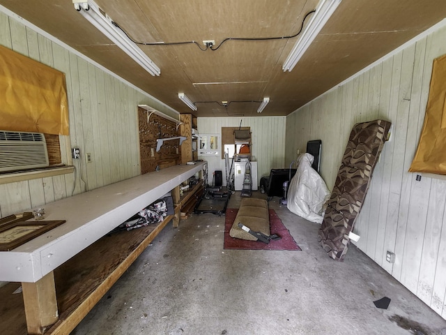 7309 Faulkner Lake Rd, North Little Rock, AR 72117 - miscellaneous room featuring wood walls, concrete flooring, cooling unit, and a workshop area