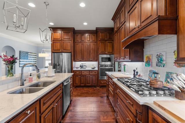 203 Miramar Blvd, Little Rock, AR 72223 - kitchen featuring appliances with stainless steel finishes, dark wood finished floors, decorative light fixtures, crown molding, and custom exhaust hood