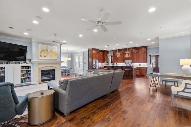 203 Miramar Blvd, Little Rock, AR 72223 - living room featuring ceiling fan, crown molding, recessed lighting, dark wood-style flooring, and arched walkways