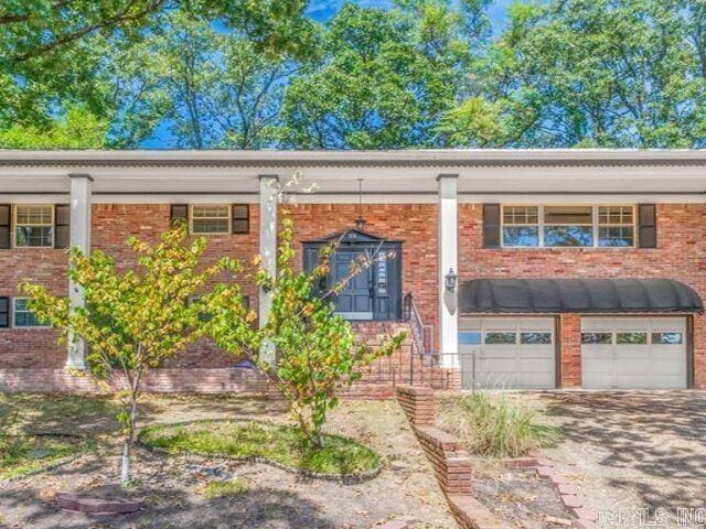 22 Nob Hill Cv, Little Rock, AR 72205 - split foyer home with brick siding, an attached garage, and driveway