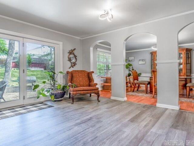 22 Nob Hill Cv, Little Rock, AR 72205 - living area featuring arched walkways, wood finished floors, and crown molding