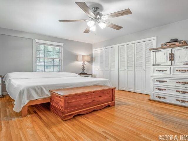 22 Nob Hill Cv, Little Rock, AR 72205 - bedroom with light wood-style floors, multiple closets, and ceiling fan