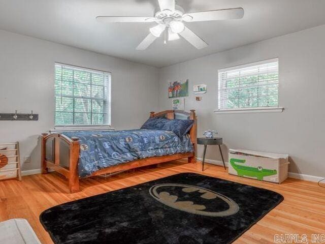 22 Nob Hill Cv, Little Rock, AR 72205 - bedroom featuring wood finished floors, multiple windows, and a ceiling fan