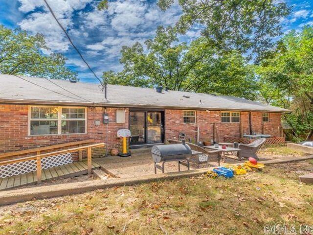 22 Nob Hill Cv, Little Rock, AR 72205 - back of property featuring brick siding, a patio, and a deck