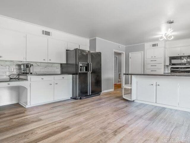 22 Nob Hill Cv, Little Rock, AR 72205 - kitchen with black appliances, light wood-type flooring, and dark countertops