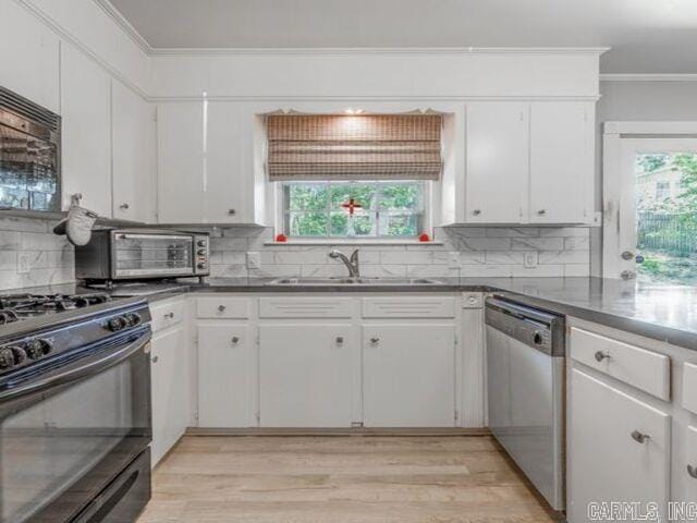 22 Nob Hill Cv, Little Rock, AR 72205 - kitchen featuring stainless steel dishwasher, black range with gas stovetop, ornamental molding, light wood-style flooring, and decorative backsplash