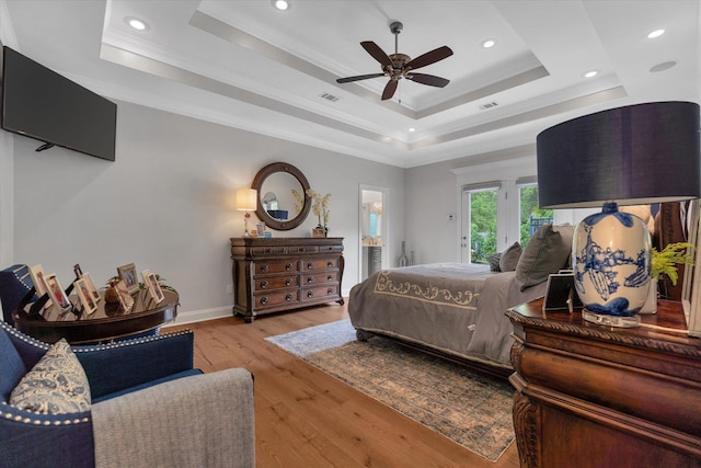 4260 Weldon Cv, Jonesboro, AR 72404 - bedroom with a tray ceiling, wood finished floors, recessed lighting, crown molding, and access to outside