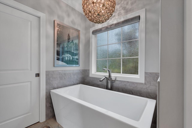 4260 Weldon Cv, Jonesboro, AR 72404 - bathroom with a freestanding bath and tile walls