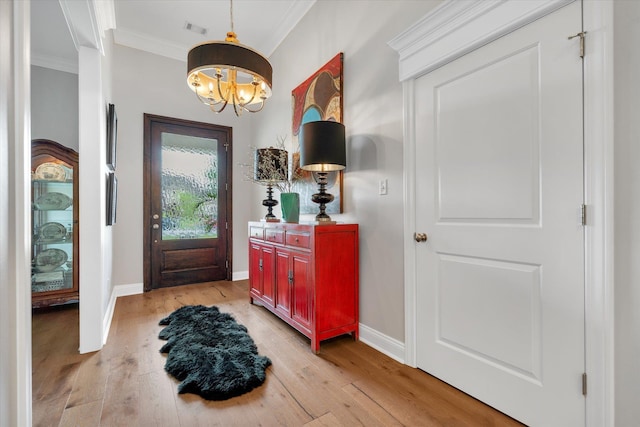 4260 Weldon Cv, Jonesboro, AR 72404 - entryway featuring crown molding, light wood finished floors, and a chandelier
