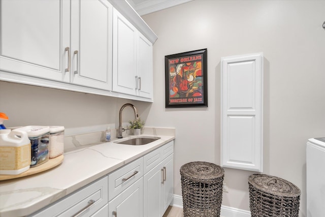 4260 Weldon Cv, Jonesboro, AR 72404 - laundry area featuring cabinet space, ornamental molding, and washer / clothes dryer