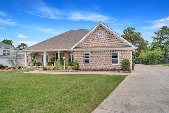 4260 Weldon Cv, Jonesboro, AR 72404 - view of front of home with brick siding, a front yard, and roof with shingles