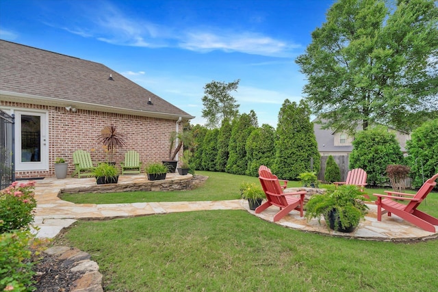 4260 Weldon Cv, Jonesboro, AR 72404 - view of green lawn featuring a patio area and a fire pit