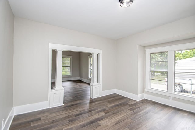2708 Rock St, Little Rock, AR 72206 - empty room with ornate columns, plenty of natural light, and dark wood-style floors