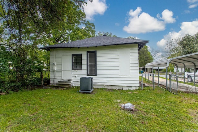 2708 Rock St, Little Rock, AR 72206 - back of property featuring a carport, roof with shingles, and crawl space