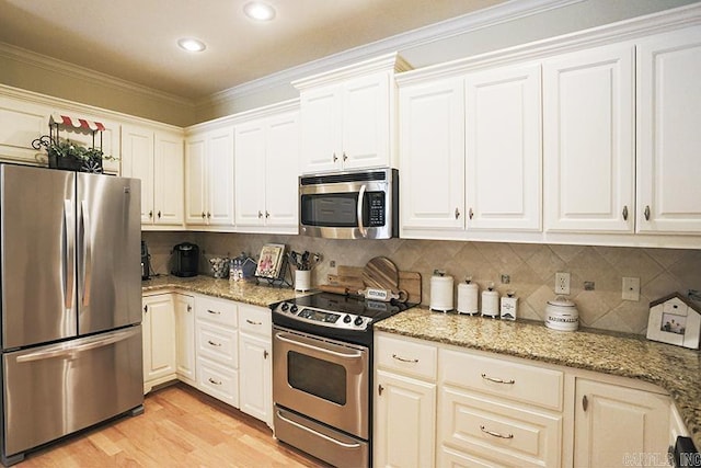 29 Taylor Park Loop, Little Rock, AR 72211 - kitchen featuring appliances with stainless steel finishes, light wood-style floors, decorative backsplash, light stone countertops, and recessed lighting