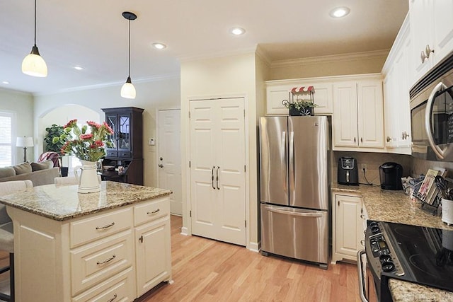 29 Taylor Park Loop, Little Rock, AR 72211 - kitchen featuring appliances with stainless steel finishes, light wood-style flooring, open floor plan, light stone counters, and decorative light fixtures