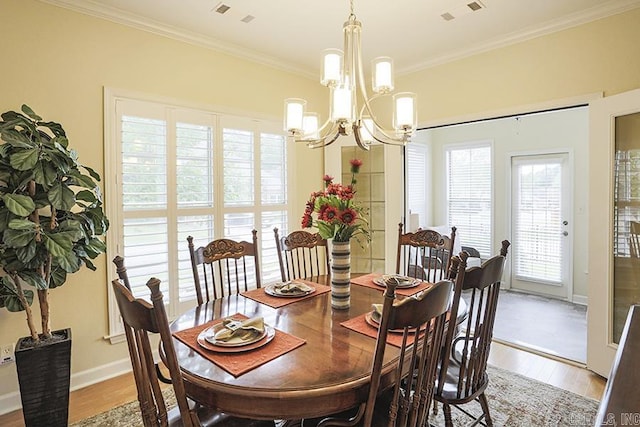 29 Taylor Park Loop, Little Rock, AR 72211 - dining area featuring light wood-type flooring, a chandelier, ornamental molding, and healthy amount of natural light