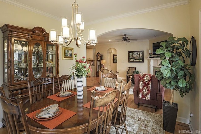 29 Taylor Park Loop, Little Rock, AR 72211 - dining room with arched walkways, ceiling fan, wood finished floors, crown molding, and a chandelier