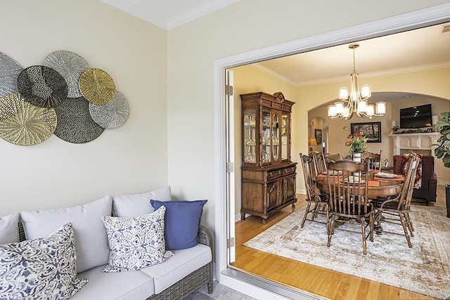 29 Taylor Park Loop, Little Rock, AR 72211 - dining room with arched walkways, a chandelier, wood finished floors, and ornamental molding