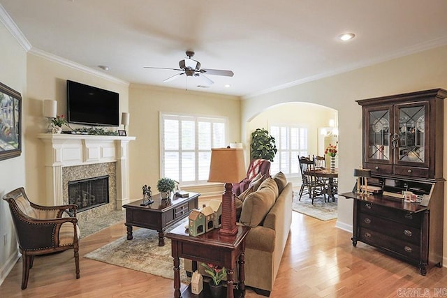 29 Taylor Park Loop, Little Rock, AR 72211 - living room featuring arched walkways, a ceiling fan, light wood-style floors, a high end fireplace, and ornamental molding