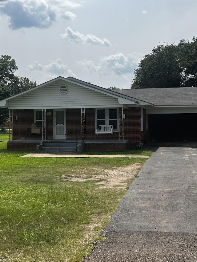 416 S Washington Ave, Murfreesboro, AR 71958 - single story home with asphalt driveway, brick siding, a front yard, and covered porch