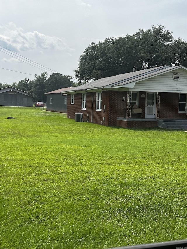 416 S Washington Ave, Murfreesboro, AR 71958 - rear view of house featuring a yard, brick siding, and a porch