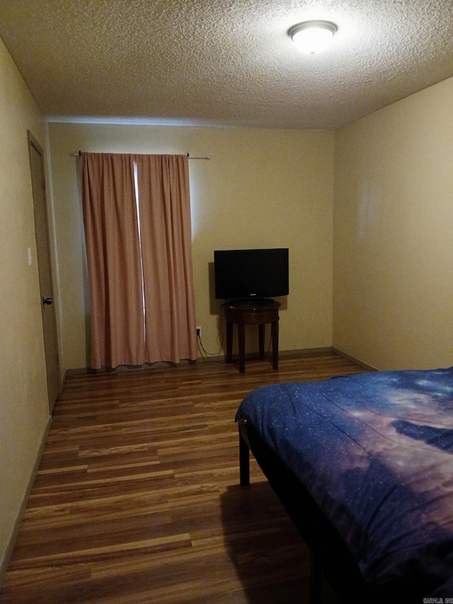 320 S Lewis St, Mineral Sprs, AR 71851 - bedroom featuring wood finished floors and a textured ceiling