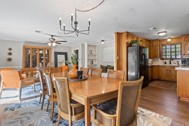 1920 W Arch Ave, Searcy, AR 72143 - dining room with a chandelier, a ceiling fan, wood finished floors, and ornamental molding