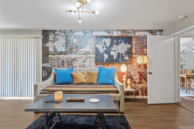 1920 W Arch Ave, Searcy, AR 72143 - sitting room with a textured ceiling, wood finished floors, and brick wall