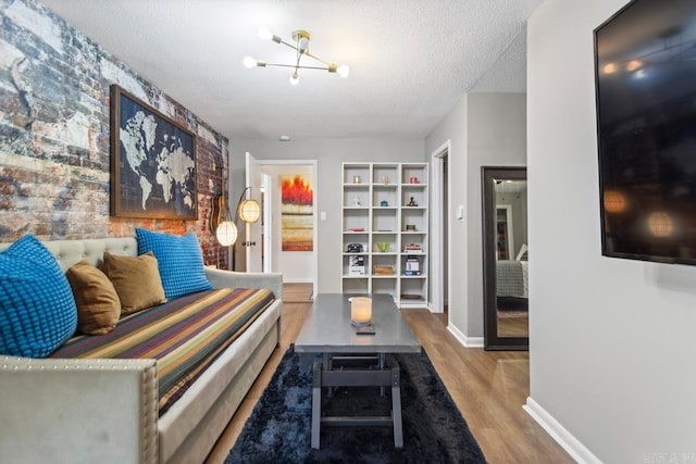 1920 W Arch Ave, Searcy, AR 72143 - living area with wood finished floors, a textured ceiling, and a chandelier