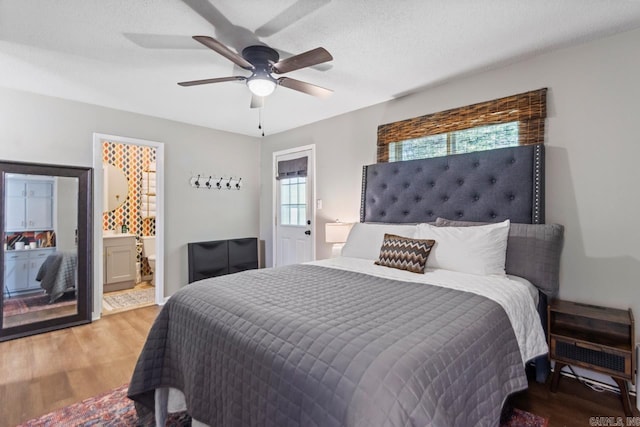 1920 W Arch Ave, Searcy, AR 72143 - bedroom featuring wood finished floors, ensuite bath, and a ceiling fan