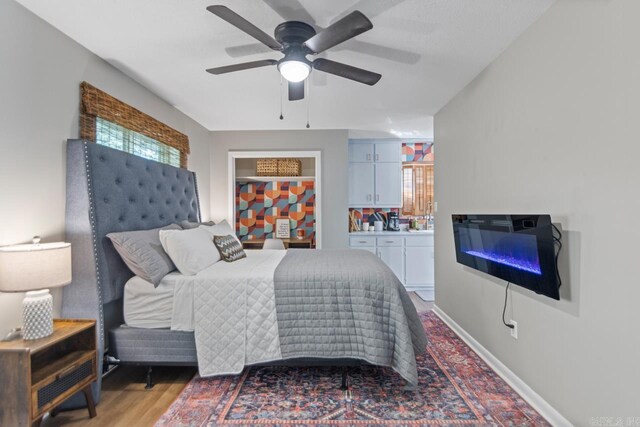1920 W Arch Ave, Searcy, AR 72143 - bedroom with multiple windows, a ceiling fan, and light wood-style floors