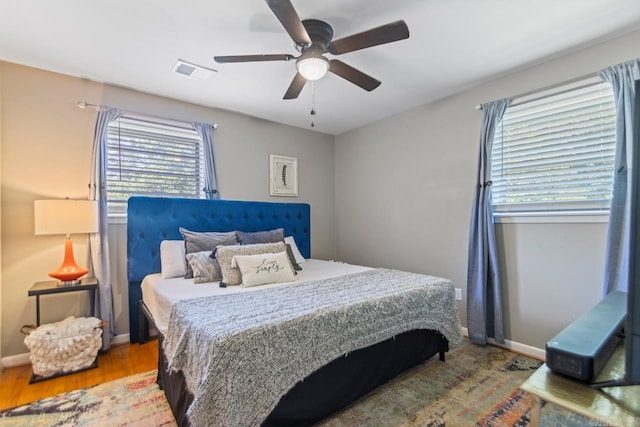 1920 W Arch Ave, Searcy, AR 72143 - bedroom featuring wood finished floors, multiple windows, and a ceiling fan