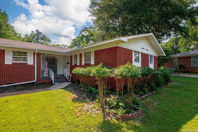 1920 W Arch Ave, Searcy, AR 72143 - ranch-style house with brick siding, a front yard, and covered porch