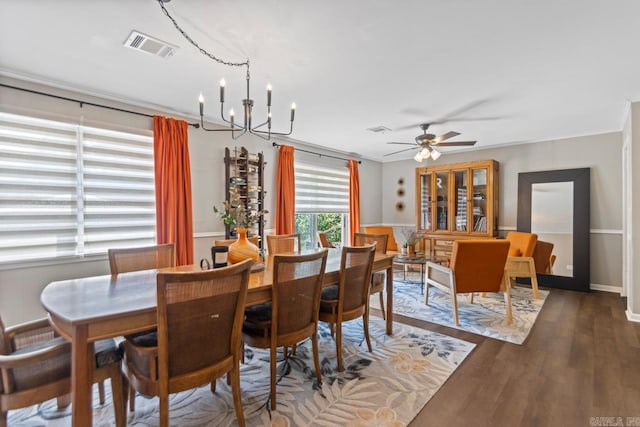 1920 W Arch Ave, Searcy, AR 72143 - dining area featuring wood finished floors, ceiling fan, and a chandelier