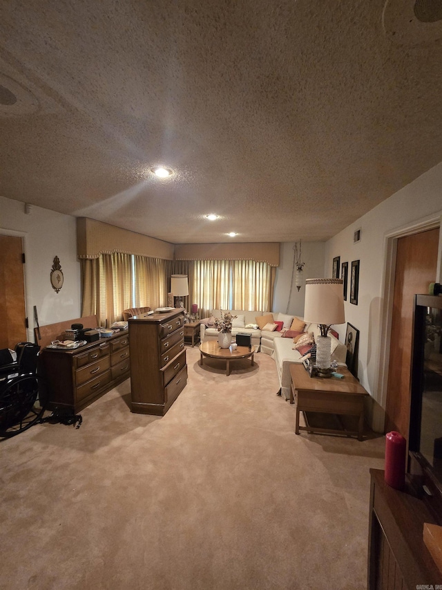 living area featuring light colored carpet, a textured ceiling, and an office area