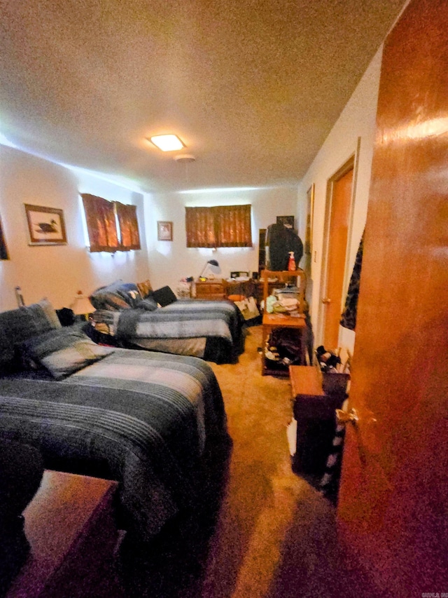 bedroom featuring carpet floors and a textured ceiling