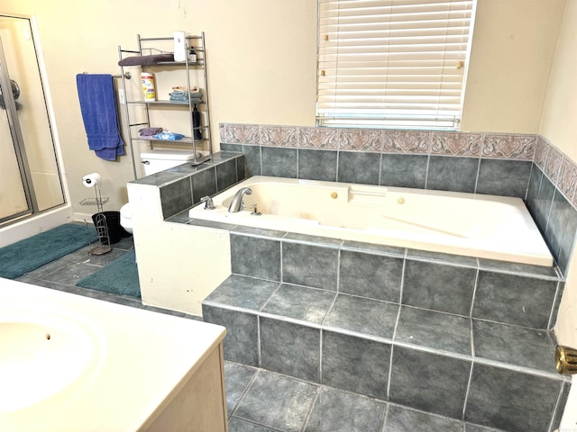 full bath featuring a jetted tub, vanity, and a shower with door